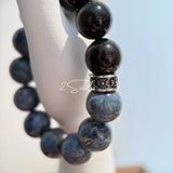 This is a bracelet consists of Blue Denim Pietersite and Golden Sheen Obsidian. The color of the bracelet is denim blue and black, accented by sleek silver spacer.
