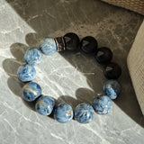 This is a bracelet consists of Blue Denim Pietersite and Golden Sheen Obsidian. The color of the bracelet is denim blue and black, accented by sleek silver spacer.