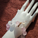 This crystal band pairs Rose Quartz with White Phantom Quartz and a hopping agate rabbit accent.