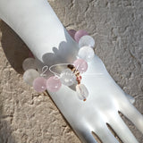 This natural crystal bracelet features a serene mix of white phantom quartz, soft rose quartz, and luminous citrine beads, creating a light, airy aesthetic. Adorned with delicate star-and-moon bodhi seed accents and a milky white chalcedony pendant, it adds a touch of gentle elegance to everyday wear.
