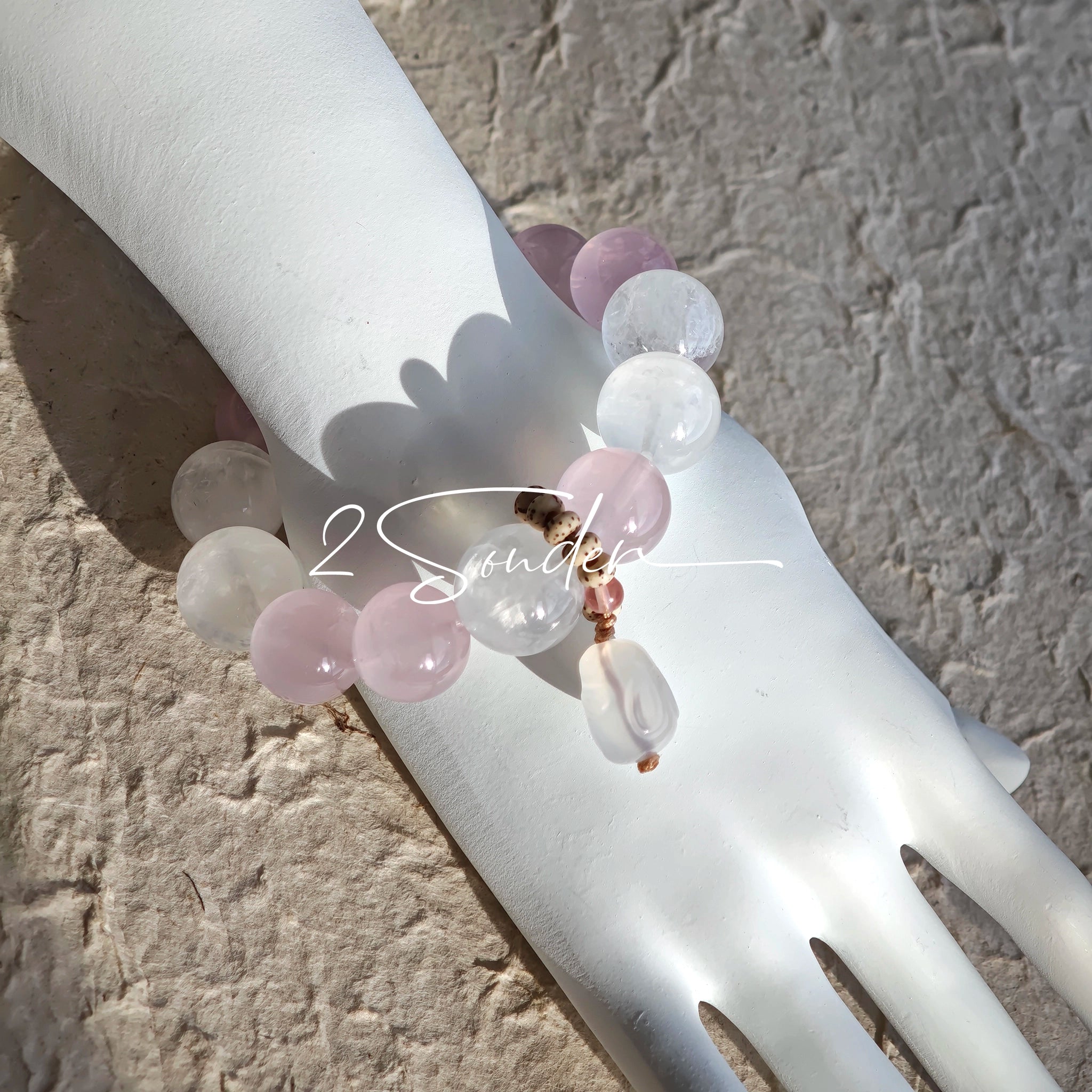 This natural crystal bracelet features a serene mix of white phantom quartz, soft rose quartz, and luminous citrine beads, creating a light, airy aesthetic. Adorned with delicate star-and-moon bodhi seed accents and a milky white chalcedony pendant, it adds a touch of gentle elegance to everyday wear.