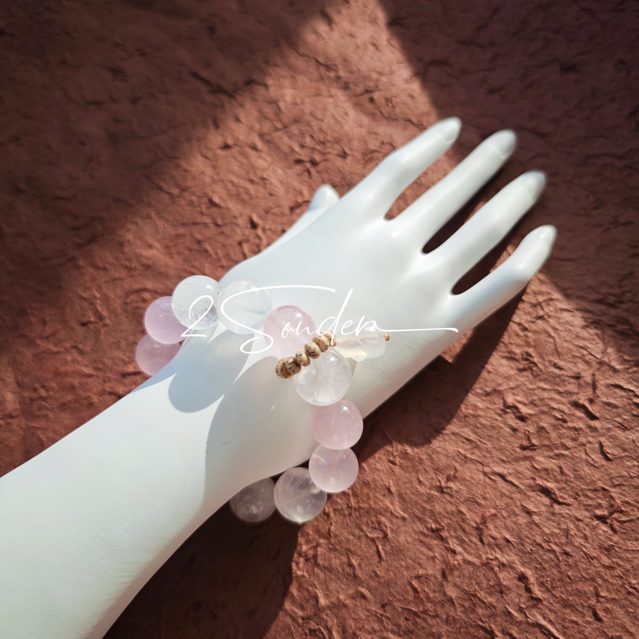 This natural crystal bracelet features a serene mix of white phantom quartz, soft rose quartz, and luminous citrine beads, creating a light, airy aesthetic. Adorned with delicate star-and-moon bodhi seed accents and a milky white chalcedony pendant, it adds a touch of gentle elegance to everyday wear.
