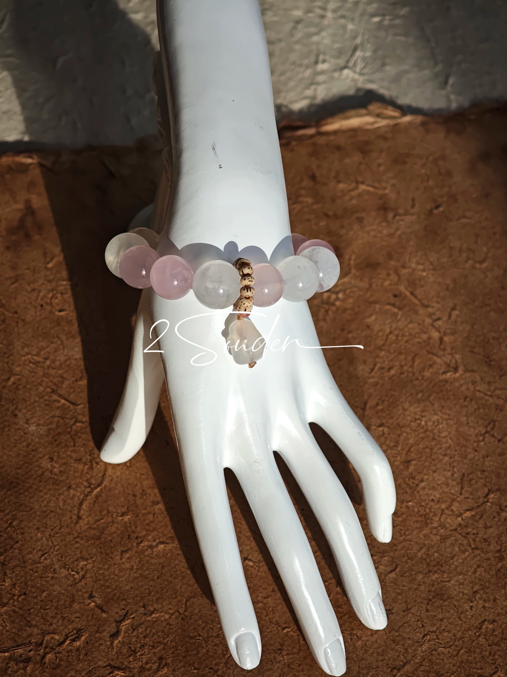 This natural crystal bracelet features a serene mix of white phantom quartz, soft rose quartz, and luminous citrine beads, creating a light, airy aesthetic. Adorned with delicate star-and-moon bodhi seed accents and a milky white chalcedony pendant, it adds a touch of gentle elegance to everyday wear.