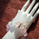 This natural crystal bracelet features a serene mix of white phantom quartz, soft rose quartz, and luminous citrine beads, creating a light, airy aesthetic. Adorned with delicate star-and-moon bodhi seed accents and a milky white chalcedony pendant, it adds a touch of gentle elegance to everyday wear.