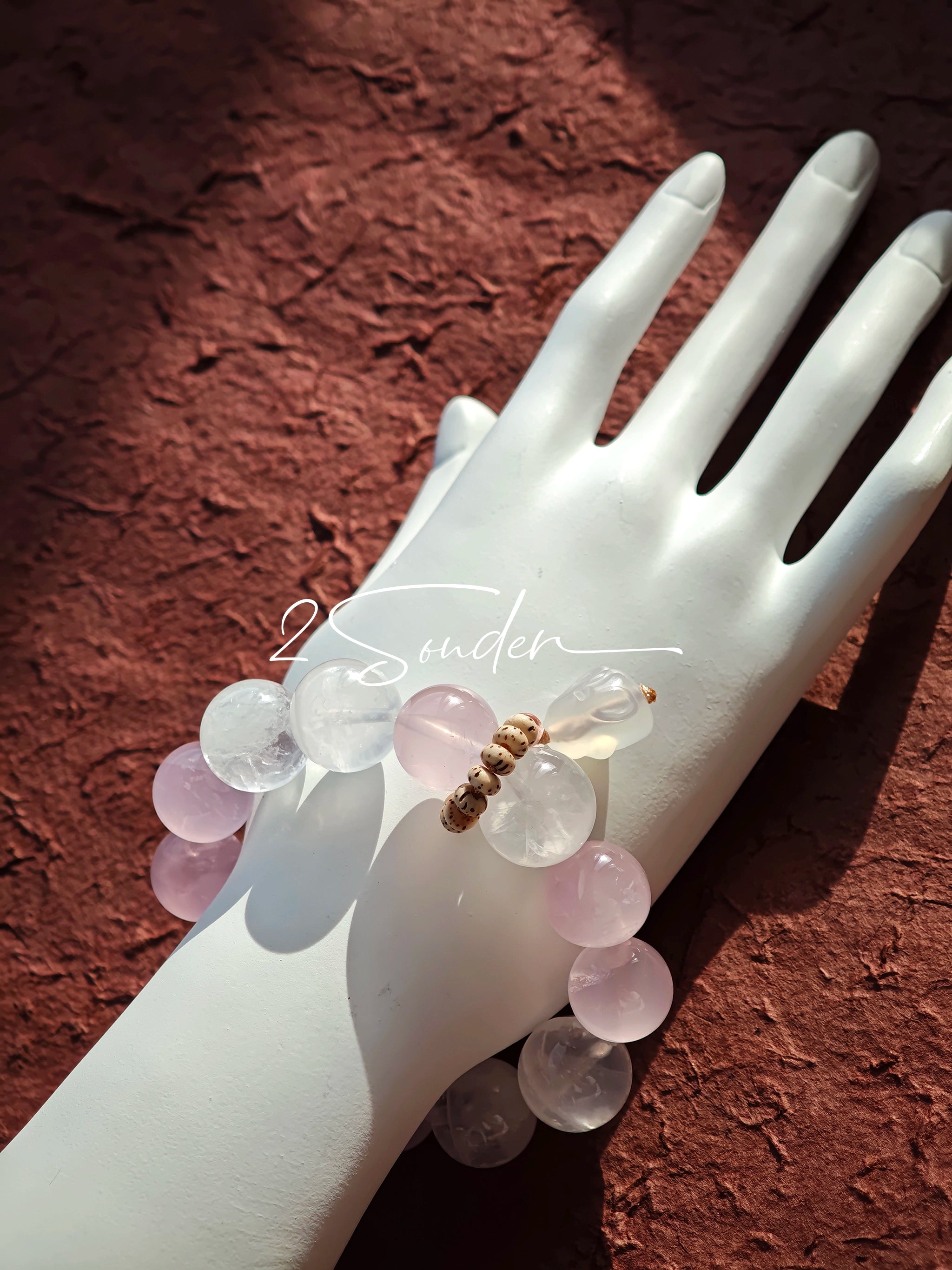 This natural crystal bracelet features a serene mix of white phantom quartz, soft rose quartz, and luminous citrine beads, creating a light, airy aesthetic. Adorned with delicate star-and-moon bodhi seed accents and a milky white chalcedony pendant, it adds a touch of gentle elegance to everyday wear.