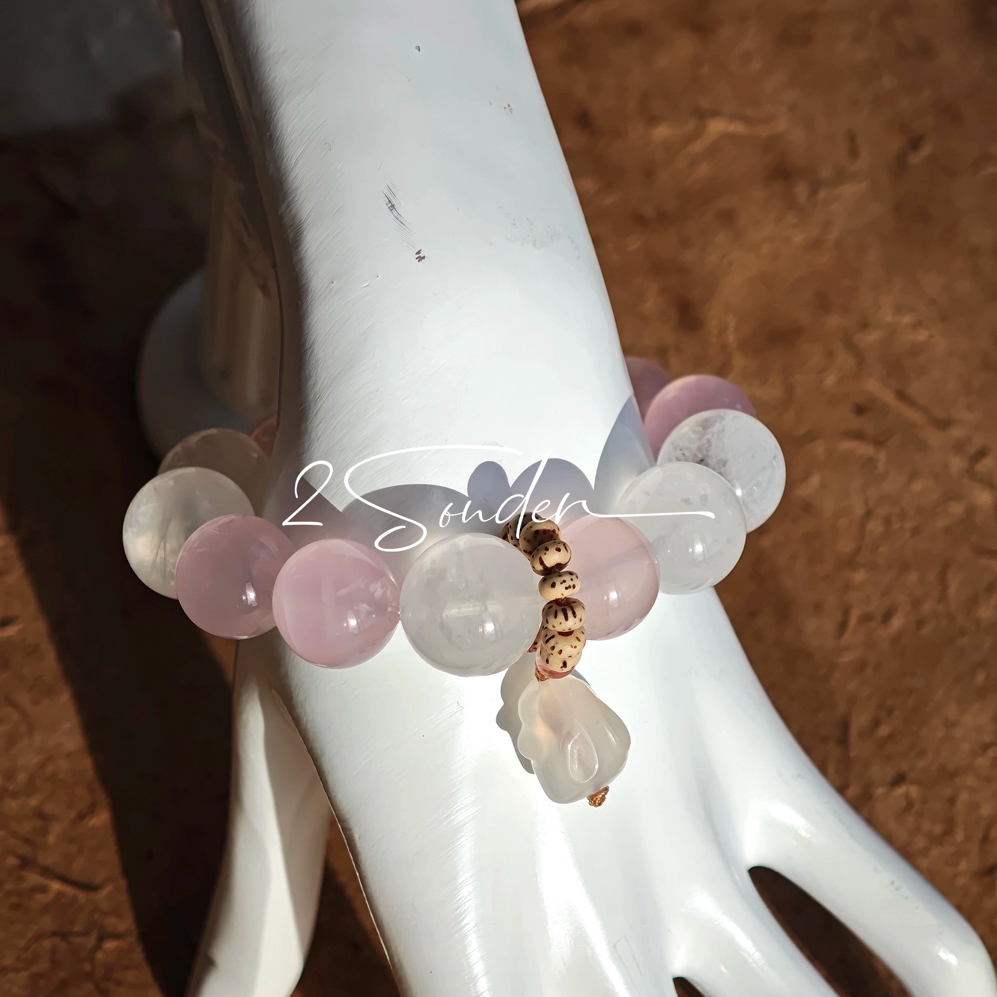 This natural crystal bracelet features a serene mix of white phantom quartz, soft rose quartz, and luminous citrine beads, creating a light, airy aesthetic. Adorned with delicate star-and-moon bodhi seed accents and a milky white chalcedony pendant, it adds a touch of gentle elegance to everyday wear.
