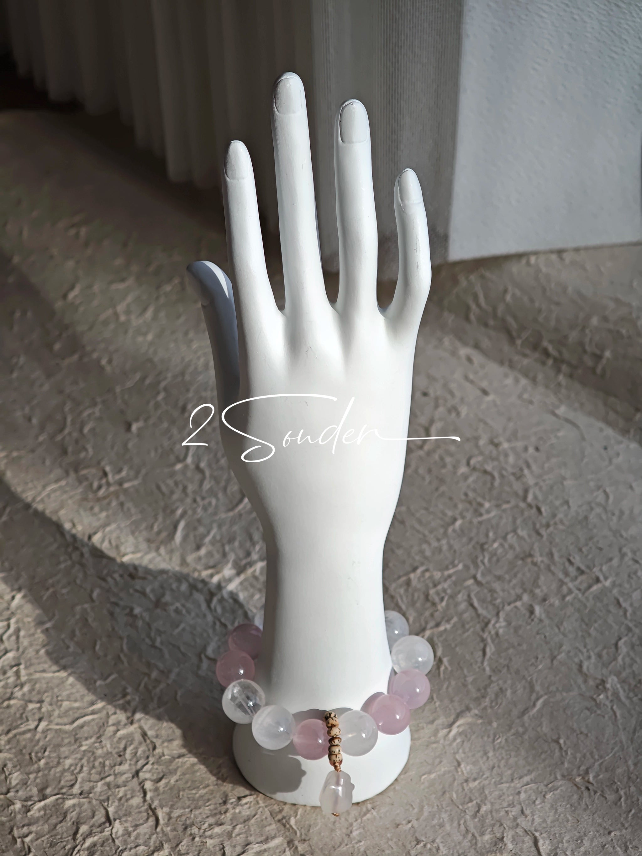 This natural crystal bracelet features a serene mix of white phantom quartz, soft rose quartz, and luminous citrine beads, creating a light, airy aesthetic. Adorned with delicate star-and-moon bodhi seed accents and a milky white chalcedony pendant, it adds a touch of gentle elegance to everyday wear.
