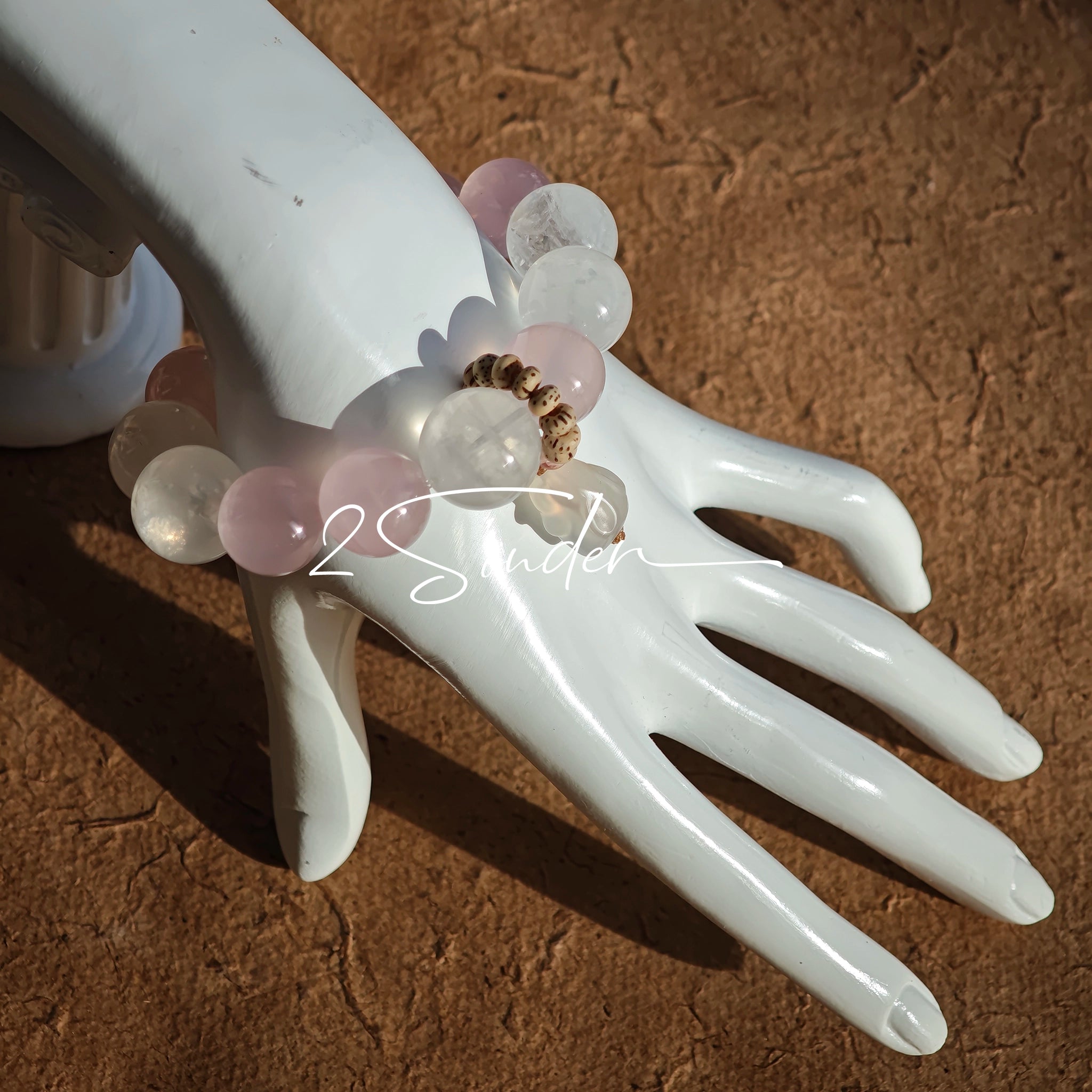 This natural crystal bracelet features a serene mix of white phantom quartz, soft rose quartz, and luminous citrine beads, creating a light, airy aesthetic. Adorned with delicate star-and-moon bodhi seed accents and a milky white chalcedony pendant, it adds a touch of gentle elegance to everyday wear.