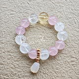 This natural crystal bracelet features a serene mix of white phantom quartz, soft rose quartz, and luminous citrine beads, creating a light, airy aesthetic. Adorned with delicate star-and-moon bodhi seed accents and a milky white chalcedony pendant, it adds a touch of gentle elegance to everyday wear.