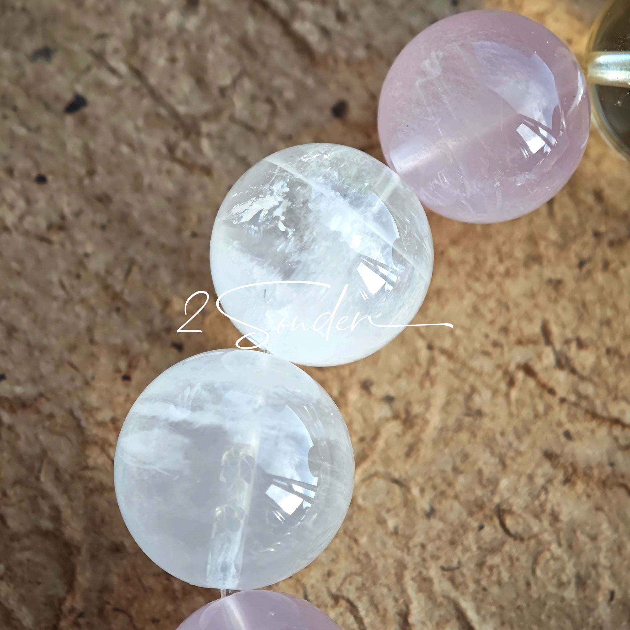 This natural crystal bracelet features a serene mix of white phantom quartz, soft rose quartz, and luminous citrine beads, creating a light, airy aesthetic. Adorned with delicate star-and-moon bodhi seed accents and a milky white chalcedony pendant, it adds a touch of gentle elegance to everyday wear.