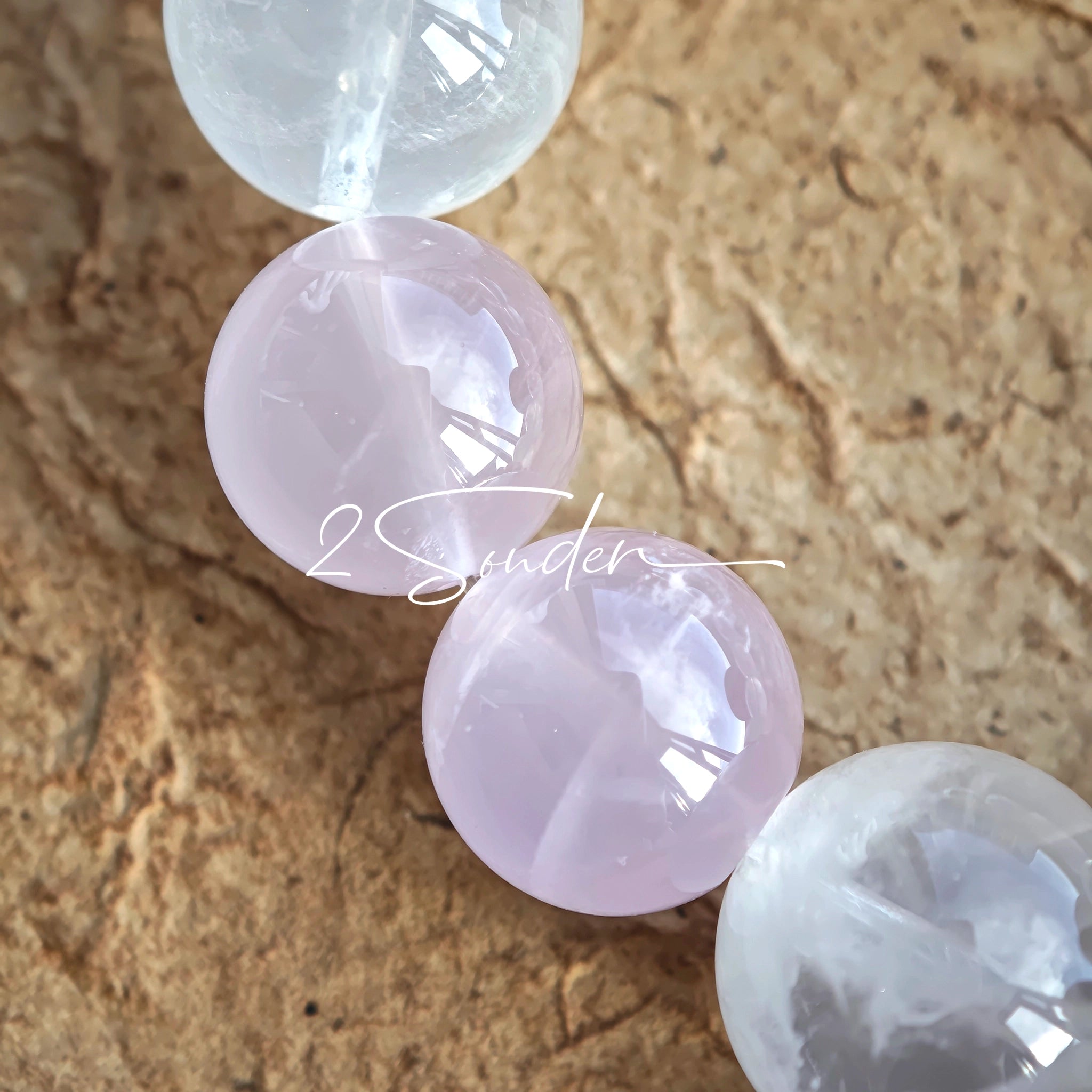 This natural crystal bracelet features a serene mix of white phantom quartz, soft rose quartz, and luminous citrine beads, creating a light, airy aesthetic. Adorned with delicate star-and-moon bodhi seed accents and a milky white chalcedony pendant, it adds a touch of gentle elegance to everyday wear.