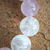 This natural crystal bracelet features a serene mix of white phantom quartz, soft rose quartz, and luminous citrine beads, creating a light, airy aesthetic. Adorned with delicate star-and-moon bodhi seed accents and a milky white chalcedony pendant, it adds a touch of gentle elegance to everyday wear.