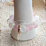 This natural crystal bracelet features a serene mix of white phantom quartz, soft rose quartz, and luminous citrine beads, creating a light, airy aesthetic. Adorned with delicate star-and-moon bodhi seed accents and a milky white chalcedony pendant, it adds a touch of gentle elegance to everyday wear.