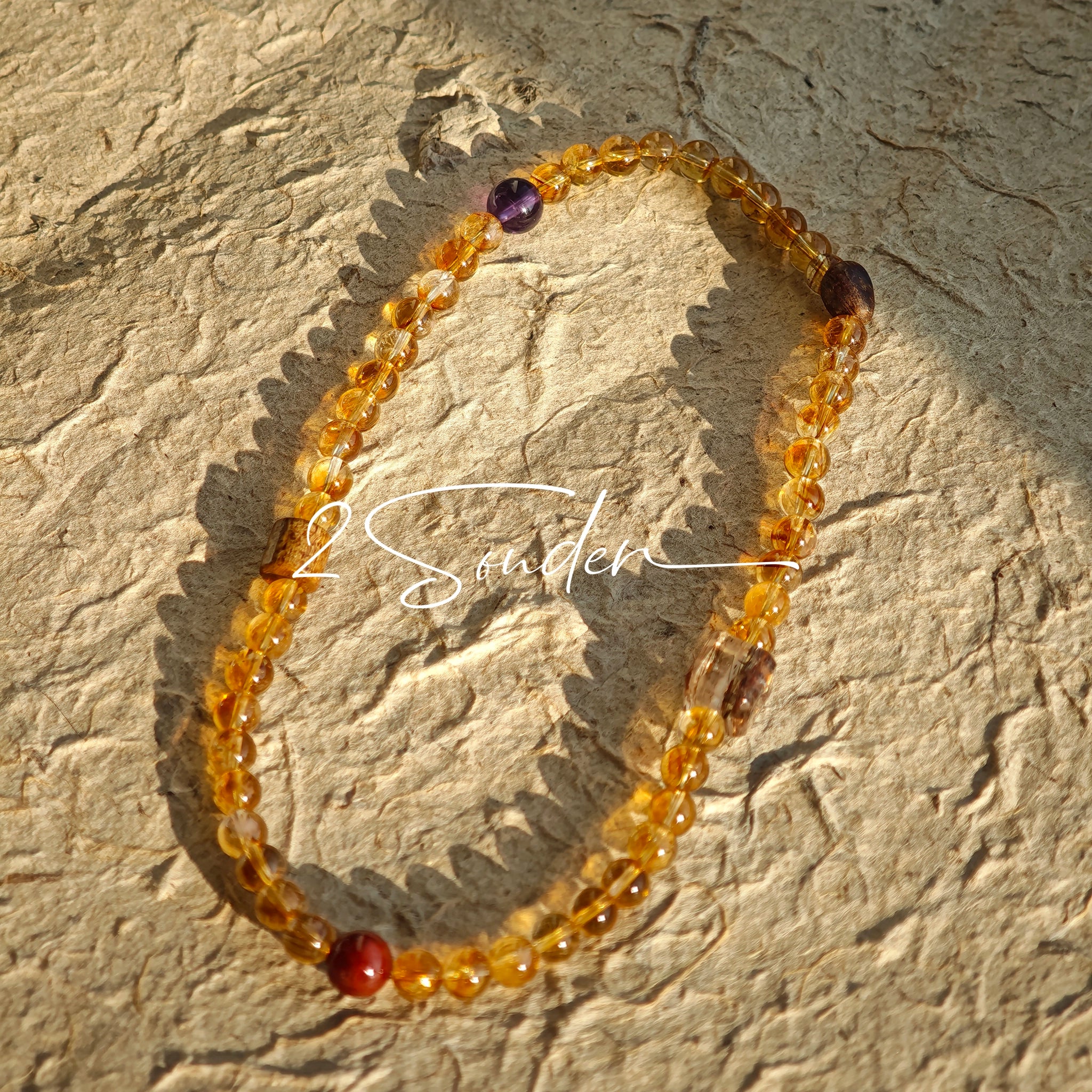 This is a layered bracelet consists of citrine beads, amethyst and aloeswood beads.