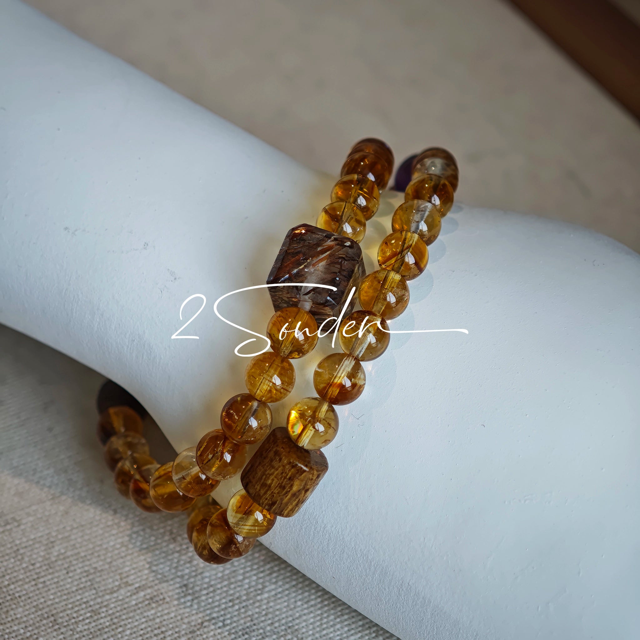 This is a layered bracelet consists of citrine beads, amethyst and aloeswood beads.