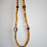 This is a layered bracelet consists of citrine beads, amethyst and aloeswood beads.