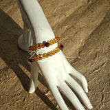This is a layered bracelet consists of citrine beads, amethyst and aloeswood beads.