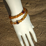 This is a layered bracelet consists of citrine beads, amethyst and aloeswood beads.