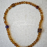 This is a layered bracelet consists of citrine beads, amethyst and aloeswood beads.