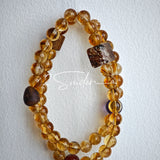 This is a layered bracelet consists of citrine beads, amethyst and aloeswood beads.