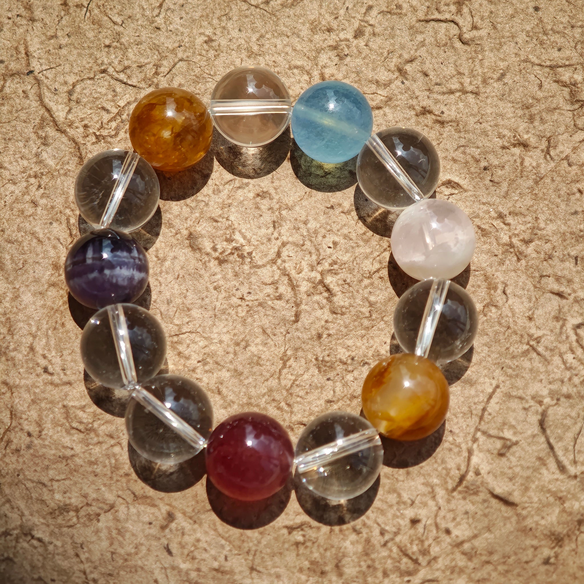 This exquisite piece features a curated blend of genuine crystals—from passionate Strawberry Quartz and tranquil Amethyst to the amplifying Clear Quartz—each selected for its unique beauty and energetic properties.