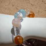 This exquisite piece features a curated blend of genuine crystals—from passionate Strawberry Quartz and tranquil Amethyst to the amplifying Clear Quartz—each selected for its unique beauty and energetic properties.