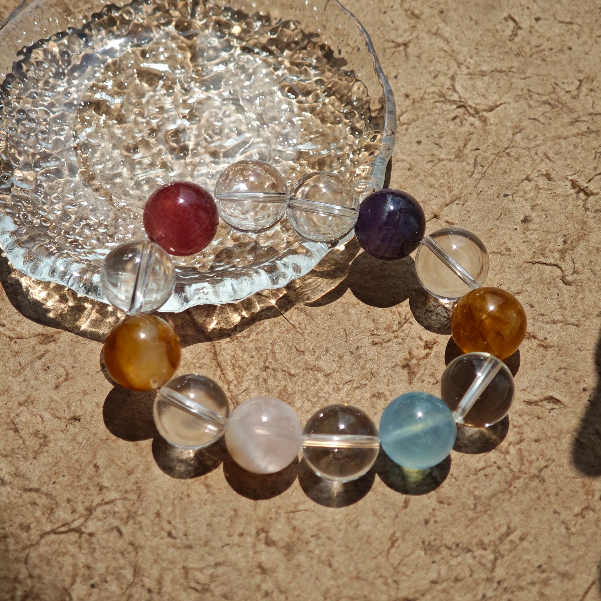 This exquisite piece features a curated blend of genuine crystals—from passionate Strawberry Quartz and tranquil Amethyst to the amplifying Clear Quartz—each selected for its unique beauty and energetic properties.