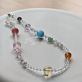 This handcrafted gemstone necklace is a stunning blend of natural crystals, featuring sparkling Herkimer Diamonds, vibrant Brazilian Amethyst, rich Pigeon's Blood Strawberry Quartz, serene Aquamarine, sunny Citrine, and luminous clear quartz, each bead hand-selected for its one-of-a-kind beauty. Strung alongside polished clear quartz spacers and accent stones, the necklace balances bold, colorful statement beads with delicate, shimmering crystal details, creating a piece that feels both earthy and ethereal.