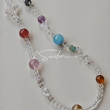 This handcrafted gemstone necklace is a stunning blend of natural crystals, featuring sparkling Herkimer Diamonds, vibrant Brazilian Amethyst, rich Pigeon's Blood Strawberry Quartz, serene Aquamarine, sunny Citrine, and luminous clear quartz, each bead hand-selected for its one-of-a-kind beauty. Strung alongside polished clear quartz spacers and accent stones, the necklace balances bold, colorful statement beads with delicate, shimmering crystal details, creating a piece that feels both earthy and ethereal.