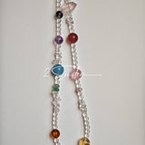This handcrafted gemstone necklace is a stunning blend of natural crystals, featuring sparkling Herkimer Diamonds, vibrant Brazilian Amethyst, rich Pigeon's Blood Strawberry Quartz, serene Aquamarine, sunny Citrine, and luminous clear quartz, each bead hand-selected for its one-of-a-kind beauty. Strung alongside polished clear quartz spacers and accent stones, the necklace balances bold, colorful statement beads with delicate, shimmering crystal details, creating a piece that feels both earthy and ethereal.
