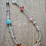 This handcrafted gemstone necklace is a stunning blend of natural crystals, featuring sparkling Herkimer Diamonds, vibrant Brazilian Amethyst, rich Pigeon's Blood Strawberry Quartz, serene Aquamarine, sunny Citrine, and luminous clear quartz, each bead hand-selected for its one-of-a-kind beauty. Strung alongside polished clear quartz spacers and accent stones, the necklace balances bold, colorful statement beads with delicate, shimmering crystal details, creating a piece that feels both earthy and ethereal.