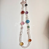 This handcrafted gemstone necklace is a stunning blend of natural crystals, featuring sparkling Herkimer Diamonds, vibrant Brazilian Amethyst, rich Pigeon's Blood Strawberry Quartz, serene Aquamarine, sunny Citrine, and luminous clear quartz, each bead hand-selected for its one-of-a-kind beauty. Strung alongside polished clear quartz spacers and accent stones, the necklace balances bold, colorful statement beads with delicate, shimmering crystal details, creating a piece that feels both earthy and ethereal.