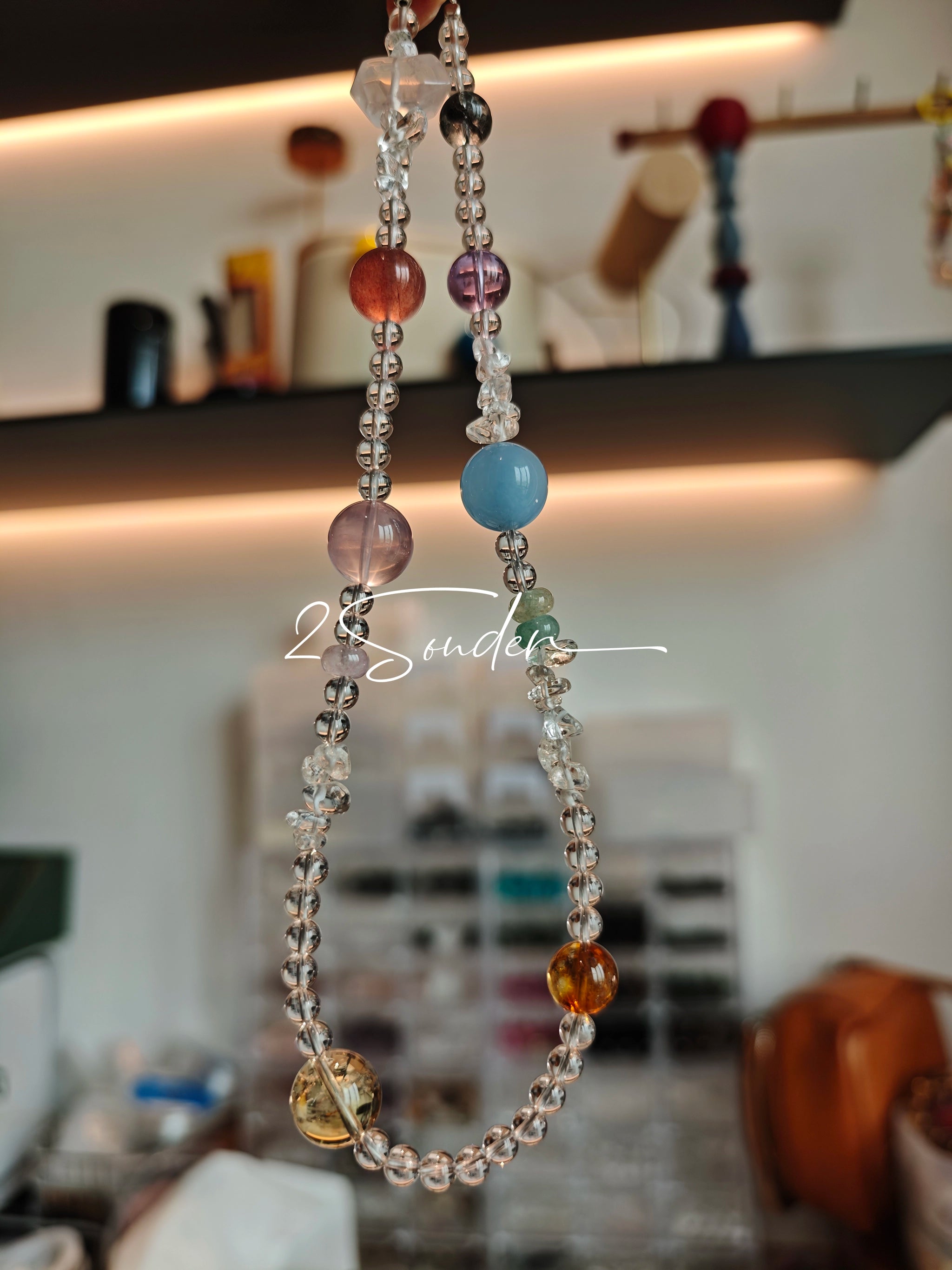 This handcrafted gemstone necklace is a stunning blend of natural crystals, featuring sparkling Herkimer Diamonds, vibrant Brazilian Amethyst, rich Pigeon's Blood Strawberry Quartz, serene Aquamarine, sunny Citrine, and luminous clear quartz, each bead hand-selected for its one-of-a-kind beauty. Strung alongside polished clear quartz spacers and accent stones, the necklace balances bold, colorful statement beads with delicate, shimmering crystal details, creating a piece that feels both earthy and ethereal.