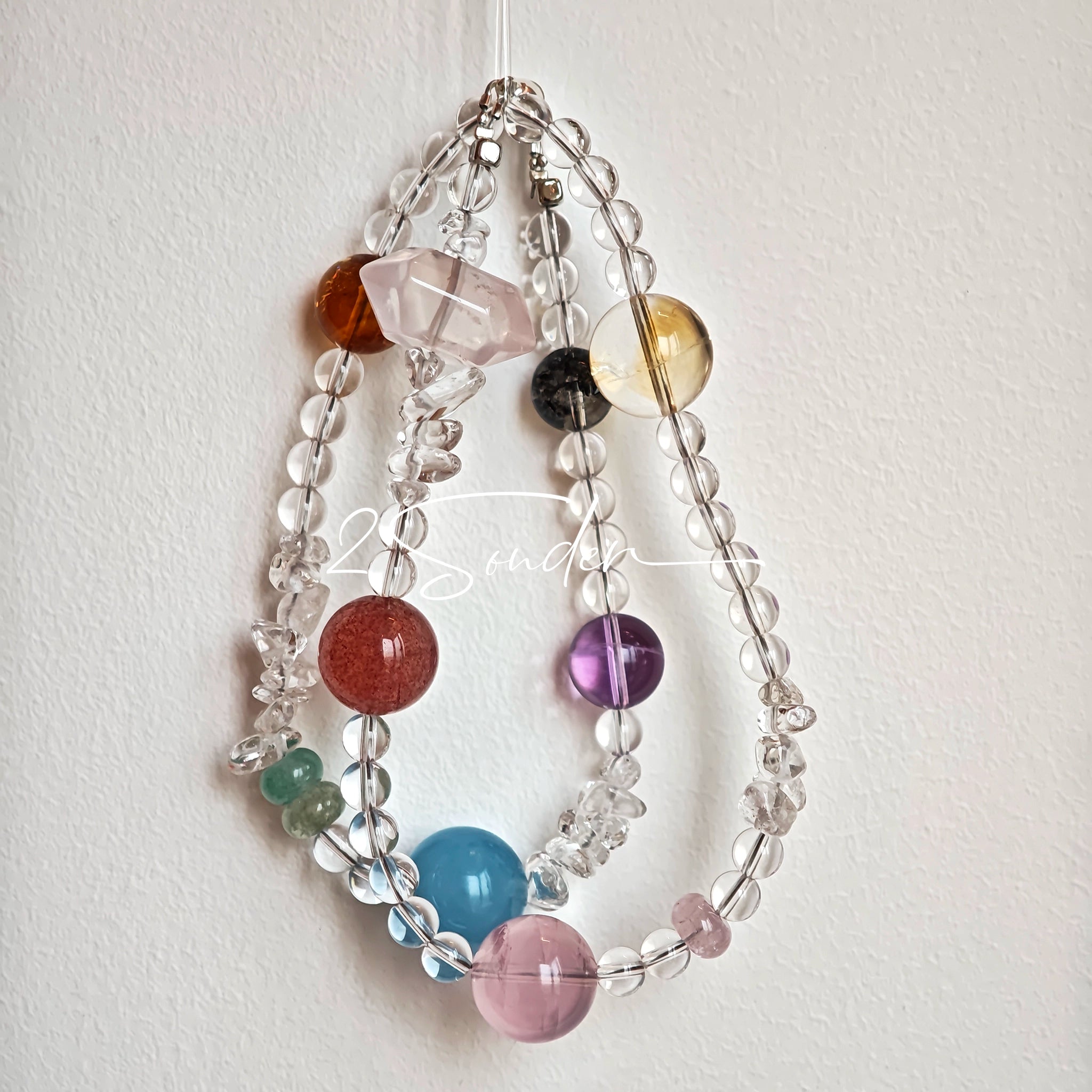 This handcrafted gemstone necklace is a stunning blend of natural crystals, featuring sparkling Herkimer Diamonds, vibrant Brazilian Amethyst, rich Pigeon's Blood Strawberry Quartz, serene Aquamarine, sunny Citrine, and luminous clear quartz, each bead hand-selected for its one-of-a-kind beauty. Strung alongside polished clear quartz spacers and accent stones, the necklace balances bold, colorful statement beads with delicate, shimmering crystal details, creating a piece that feels both earthy and ethereal.