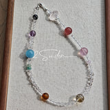This handcrafted gemstone necklace is a stunning blend of natural crystals, featuring sparkling Herkimer Diamonds, vibrant Brazilian Amethyst, rich Pigeon's Blood Strawberry Quartz, serene Aquamarine, sunny Citrine, and luminous clear quartz, each bead hand-selected for its one-of-a-kind beauty. Strung alongside polished clear quartz spacers and accent stones, the necklace balances bold, colorful statement beads with delicate, shimmering crystal details, creating a piece that feels both earthy and ethereal.