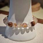 The strand tells a story: copper energy rises, agarwood grounds, and the amber gourd keeps both treasure and talisman.
