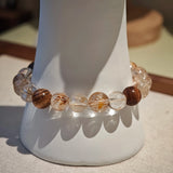 The strand tells a story: copper energy rises, agarwood grounds, and the amber gourd keeps both treasure and talisman.