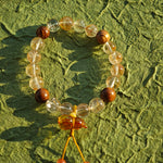 Fire-kissed crystals dance with fragrant wood, while a flower-shaped amber calabash offers ancient promise: thrive and be shielded.