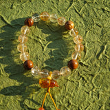 Fire-kissed crystals dance with fragrant wood, while a flower-shaped amber calabash offers ancient promise: thrive and be shielded.