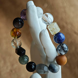 One neutral-friendly strand: rutilated quartz, white phantom, citrine, amethyst, moonstone and silver obsidian—mystery made simple.