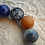 Let rutilated quartz, white phantom, citrine, amethyst, moonstone and silver obsidian tint your wrist in frosty elegance.