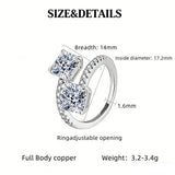 This striking bypass ring showcases two large, brilliant cushion-cut clear stones held securely in classic four-prong settings. The elegant twisted band is lined with a row of sparkling accent Cubic Zirconia stones, delivering a high-end, light luxury aesthetic that instantly catches the eye.