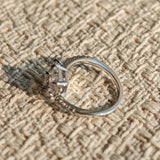 This striking bypass ring showcases two large, brilliant cushion-cut clear stones held securely in classic four-prong settings. The elegant twisted band is lined with a row of sparkling accent Cubic Zirconia stones, delivering a high-end, light luxury aesthetic that instantly catches the eye.
