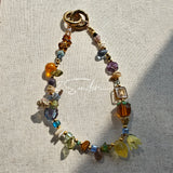 This is a bag charm that made of Czech beads. In the phone strap, there are different spacers like orange, leaves, flowers and lemon. It's with multi colors. This bag charm can also be used as a phone strap and key chain.