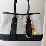 This is a bag charm that made of Czech beads. In the phone strap, there are different spacers like orange, leaves, flowers and lemon. It's with multi colors. This bag charm can also be used as a phone strap and key chain.