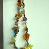 This is a bag charm that made of Czech beads. In the phone strap, there are different spacers like orange, leaves, flowers and lemon. It's with multi colors. This bag charm can also be used as a phone strap and key chain.