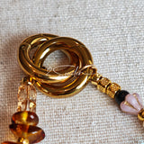 This is a bag charm that made of Czech beads. In the phone strap, there are different spacers like orange, leaves, flowers and lemon. It's with multi colors. This bag charm can also be used as a phone strap and key chain.