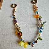 This is a bag charm that made of Czech beads. In the phone strap, there are different spacers like orange, leaves, flowers and lemon. It's with multi colors. This bag charm can also be used as a phone strap and key chain.
