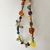 This is a bag charm that made of Czech beads. In the phone strap, there are different spacers like orange, leaves, flowers and lemon. It's with multi colors. This bag charm can also be used as a phone strap and key chain.