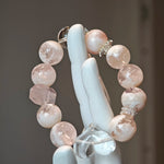 Wear a winter sunrise: phantom rose quartz for warmth, clear quartz for direction, both conspiring to unveil your truth.